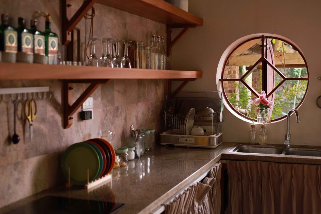 Bright kitchen counter with reusable jars, cloth bags, and fresh produce, representing a realistic zero-waste kitchen