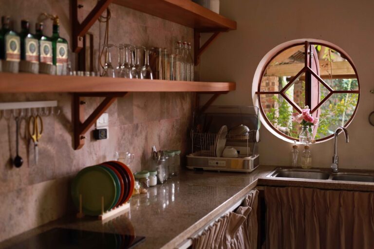 Bright kitchen counter with reusable jars, cloth bags, and fresh produce, representing a realistic zero-waste kitchen