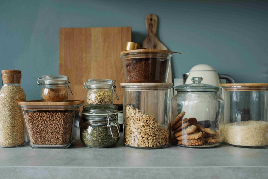 Beeswax food wraps and glass containers used as zero-waste kitchen storage alternatives